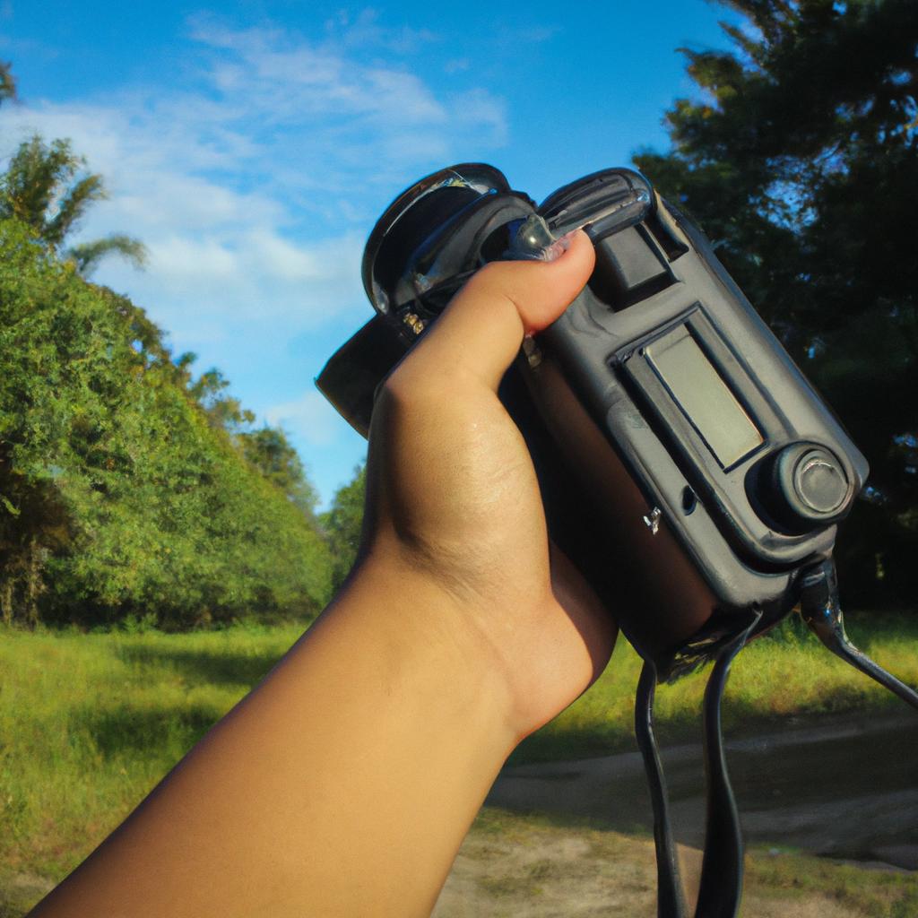 Person holding camera in nature