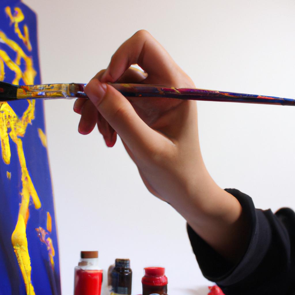 Person holding paintbrush, creating artwork